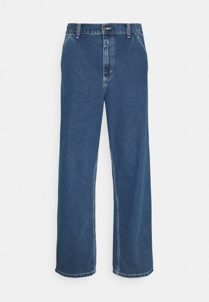 Blue denim jeans with a straight cut, five-pocket design, metal button closure, and visible stitching along seams and hem.