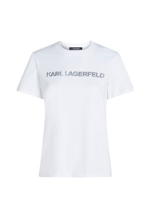 Bílý bavlněný tričko s krátkými rukávy, s nápisem "KARL LAGERFELD" v metalické stříbrné barvě na hrudníku. Klasický design s kulatým výstřihem.