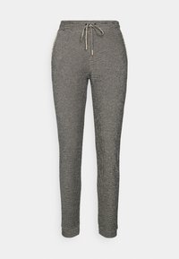 Grå och svarta stickade sweatshirtbyxor med dragsko i midjan, åtsittande muddar och sidofickor med gulddetaljer och ett strukturerat mönster.