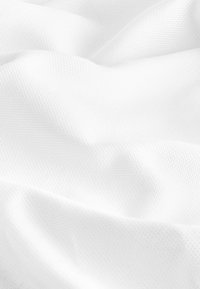 Textile fabric in white, features a smooth, textured surface with slight sheen, displaying subtle folds and drapes.
