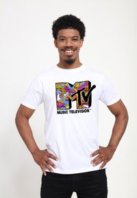 White cotton t-shirt featuring a colorful MTV logo graphic with abstract designs and black text "MUSIC TELEVISION" below the logo.