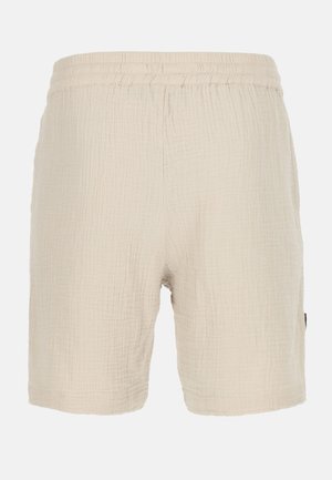 Shorts in tessuto beige con design testurizzato, dotati di una vita elasticizzata e orlo dritto, con un'etichetta laterale visibile.