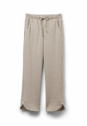 Ljusbeige sweatpants gjorda av mjukt tyg, med elastisk midja och snörning, sidofickor och bågformade fållar.