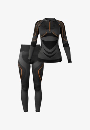Compression sportswear set in black with orange accents. Long-sleeve top features a quarter zip and textured design; fitted leggings.