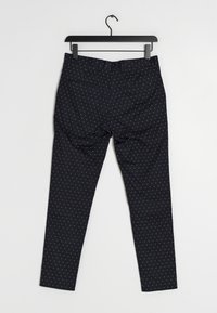 Pantaloni navy dal taglio slim, con piccoli pois bianchi, passanti per la cintura, due tasche posteriori e una texture di tessuto liscia.