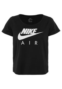 Camiseta Dri-FIT negra con logo blanco de Nike y texto 'AIR', de corte relajado y mangas cortas. La tela texturizada añade profundidad.
