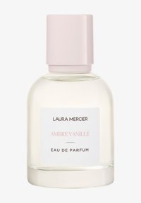 Klar glasflaska med rundad form, ljusrosa kork. Etiketten har "LAURA MERCIER" och "AMBRE VANILLE" i mörk och ljus text.