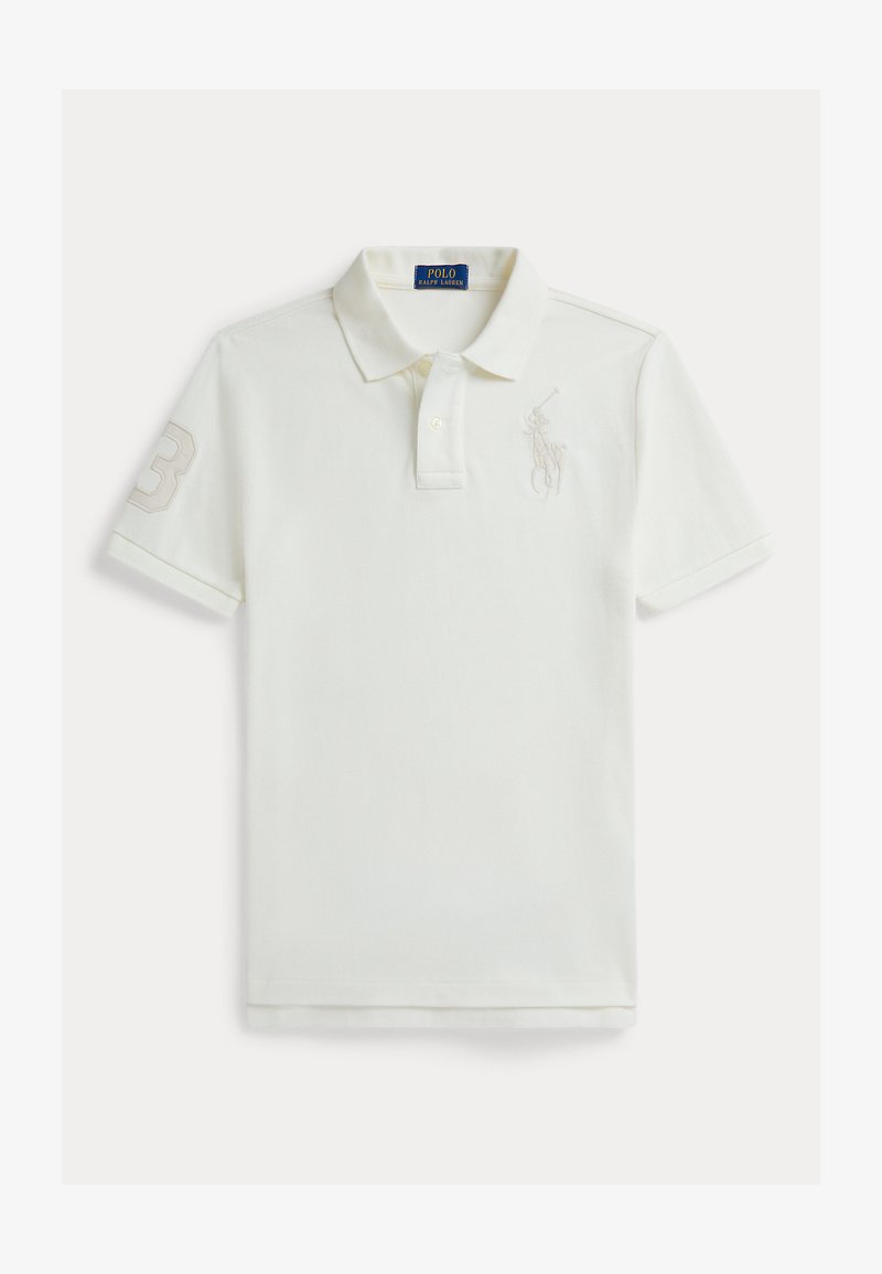 Λευκό πόλο μπλουζάκι από βαμβάκι με κοντά μανίκια, που διαθέτει τον αριθμό τρία στο αριστερό μανίκι και ένα μικρό λογότυπο στο στήθος σε πιο ανοιχτή απόχρωση.