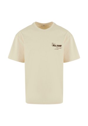 T-shirt en coton beige à coupe décontractée, avec un motif graphique brun sur le côté gauche de la poitrine, un col rond et des manches courtes.