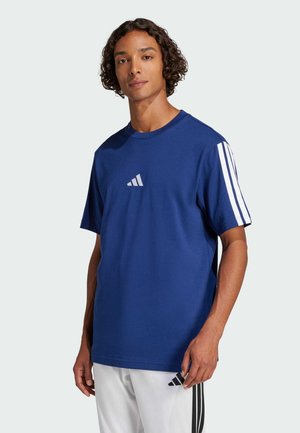 Blue cotton t-shirt with short sleeves, features three white vertical stripes on the shoulders and a small white logo at the chest.