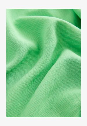 Lichtgroene stof met een gladde, gestructureerde draad, die subtiele diagonale lijnen over het oppervlak vertoont. Zacht en soepel.