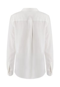 Blusa bianca a maniche lunghe, tessuto morbido, design sartoriale, polsi abbottonati, dettaglio con piega sul retro, orlo arrotondato.