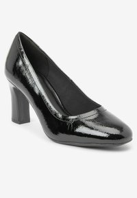 Black patent leather high heel pump with a rounded toe and a textured finish. The heel is medium height and block-shaped.