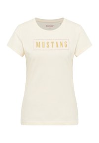 Cream-colored t-shirt featuring a golden rectangular "MUSTANG" print at the center. Made of soft cotton with short sleeves and a round neckline.