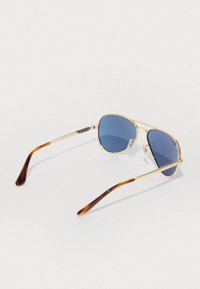 Occhiali da sole aviator in metallo dorato con lenti blu e puntali in tartaruga. Dotati di naselli regolabili per una vestibilità sicura.