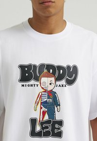 Biała bawełniana koszulka z kolorową grafiką kreskówkowego bohatera, który jest w połowie szkieletem, a w połowie ubranym charakterem, z napisem "Buddy Lee" w pogrubionej czarnej czcionce.