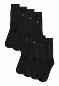 Black socks with a smooth texture, featuring small colored "N" logos in red, yellow, blue, gray, and green on the cuff. Set of eight pairs.
