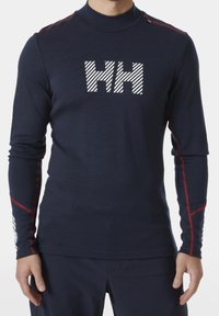 Marineblauwe longsleeve top met hoge kraag, voorzien van een wit gestreept "HH" logo op de borst en rode accentstiks langs de mouwen.