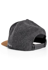 Gray wool cap with a tan leather brim, featuring a black adjustable snapback and embroidered logo detail on the side.