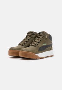 High-top sneakers in olive green with black accents, textured leather, rubber sole, lace-up design, and PUMA logo detail.