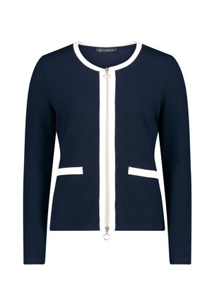 Navy Cardigan mit weißen Akzenten, Frontreißverschluss, Rundhalsausschnitt und zwei Taschen. Hergestellt aus einem strukturierten Strickmaterial. Sauberes, tailliertes Design.
