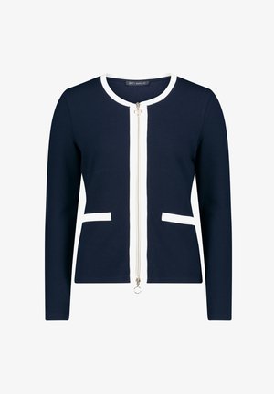 Navy Cardigan mit weißen Akzenten, Frontreißverschluss, Rundhalsausschnitt und zwei Taschen. Hergestellt aus einem strukturierten Strickmaterial. Sauberes, tailliertes Design.