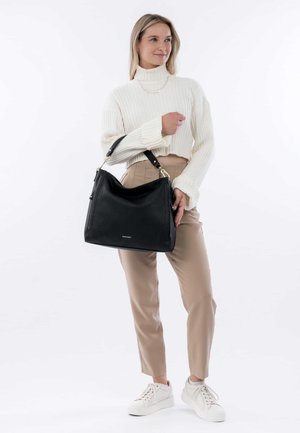 Black pebbled leather handbag with a slouchy design and a contrasting shoulder strap. Features gold hardware and a subtle logo detail.