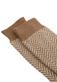 Herringbone-mønstrede strikkede benvarmere i brun og creme, med en ribbet topkant og en blød, struktureret overflade.