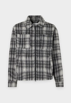 Gray and black plaid jacket with a zip front, two chest pockets, and a soft, textured fabric. Features a collared neckline and long sleeves.
