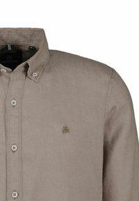Light brown linen shirt with a button-down collar, featuring white buttons and a small embroidered logo on the chest.