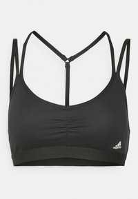 Melna sporta krūšturis ar savilkšanu priekšpusē, plānas siksniņas, kas veido racerback dizainu, ar mazu baltu adidas logo apakšējā joslā.