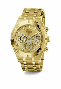 Montre dorée avec un bracelet en acier inoxydable. Le boîtier rond présente trois sous-cadrans, des index horaires blancs et un fond transparent.