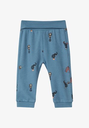 Niebieskie bawełniane dresy z nadrukiem nawiązującym do cyrku, przedstawiających zwierzęta i artystów; gumka w pasie i na mankietach, miękka tekstura.