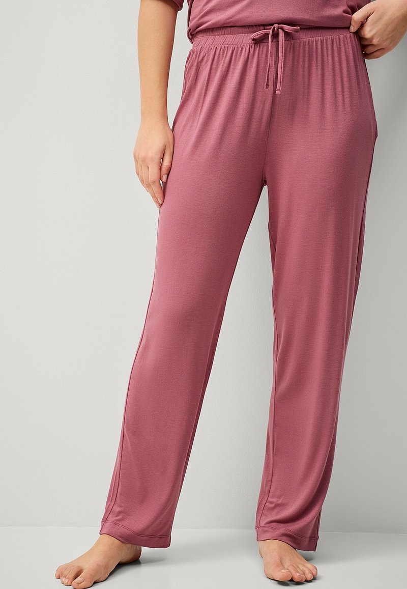 Roze loungebroek met een elastische tailleband, gemaakt van zachte, gladde stof. Heeft een ontspannen pasvorm en een recht model.