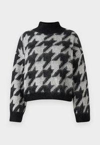 Czarny i szary krótki sweter z wysokim kołnierzem, z motywem houndstooth i puszystą fakturą. Długie, luźne rękawy zwężają się przy mankietach.