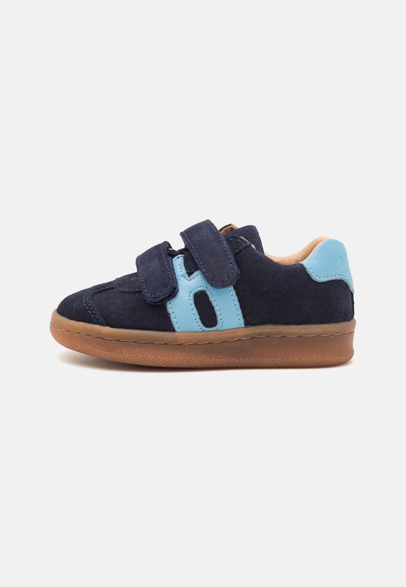 Navy suede sneaker with light blue accents and two velcro straps, featuring a brown rubber sole and a padded interior for comfort.