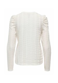 White long-sleeve top featuring a textured knitted pattern with puffed shoulder detailing and a round neck.