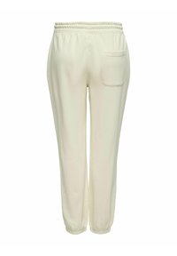 Hellbeige Sweatpants mit elastischem Bund, Seitentasche und schmal zulaufenden Bündchen. Glatte Textur mit minimalen Nähten und ohne sichtbare Muster.
