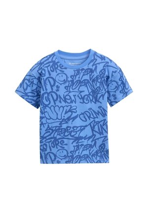 T-shirt bleu avec un imprimé graphique de divers styles de street art et de visages souriants dans des tons de bleu foncé, fabriquée en coton.