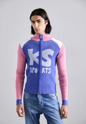 Blue and pink zip-up sports sweater with ribbed texture, featuring a large white "KS SPORTS" logo and contrasting sleeve colors.