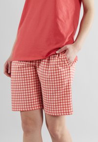 Rood-witte geruite shorts met een losse pasvorm, gemaakt van lichtgewicht stof. Heeft zijzakken en een gemiddelde taillehoogte.