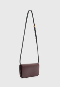 Mörkröd läder crossbody-väska med en slät yta, rektangulär form, justerbar grå rem och detaljer i guldton.