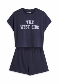 Navy blue two-piece set featuring a short-sleeve top with "THE WEST SIDE" text and elastic waist shorts, both in soft cotton material.