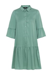 Zielona sukienka do kolan, wykonana z gładkiego materiału, z zapięciem na guziki z przodu, kołnierzykiem oraz rozkloszowanymi rękawami; ma warstwowy, falbaniasty dół.