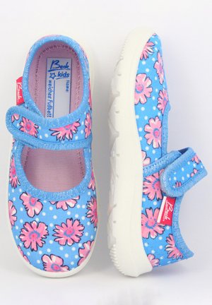 Helleblaue Canvas-Schuhe mit pinkem Blumenmuster und weißen Punkten. Klettverschluss und gepolsterte pinke Innenauskleidung. Weiße Gummisohle.