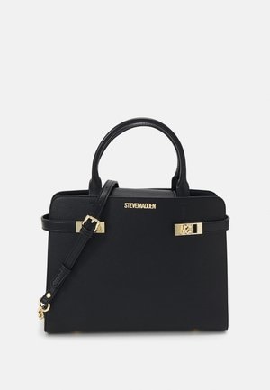 Black structured handbag with double handles, adjustable shoulder strap, and gold-tone hardware branded "Steve Madden" on front.