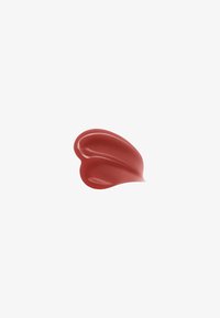 Glossy smear of medium rose-colored cream or cosmetic product on white background.