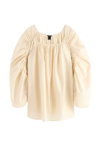 Ljusbeige blus med fyrkantig halsringning, puckelryggade ärmar och löst sittande passform. Tillverkad av ett mjukt tyg med en slät yta.