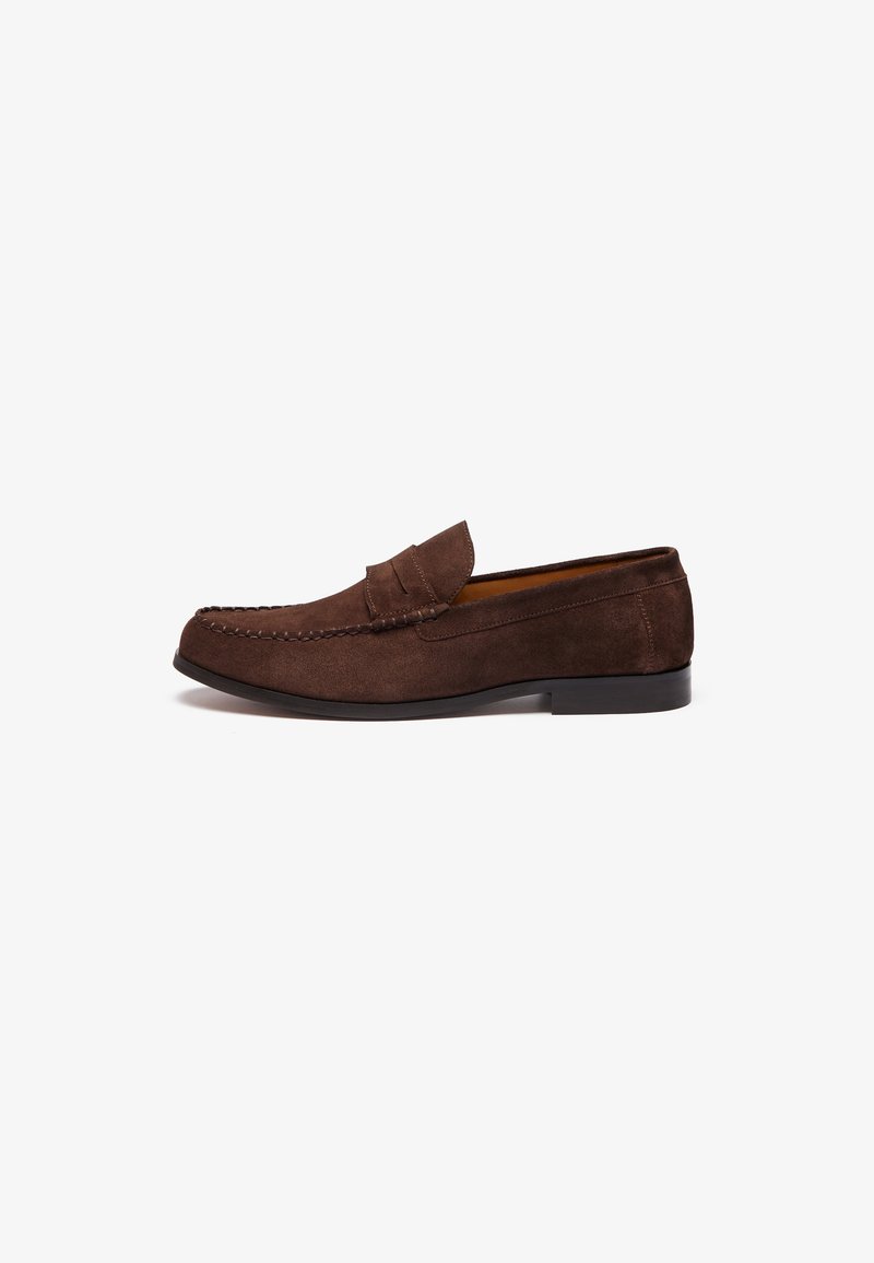 Brown suede loafers with stitched detailing, a flat sole, and a raised collar. Smooth texture and minimalist design.