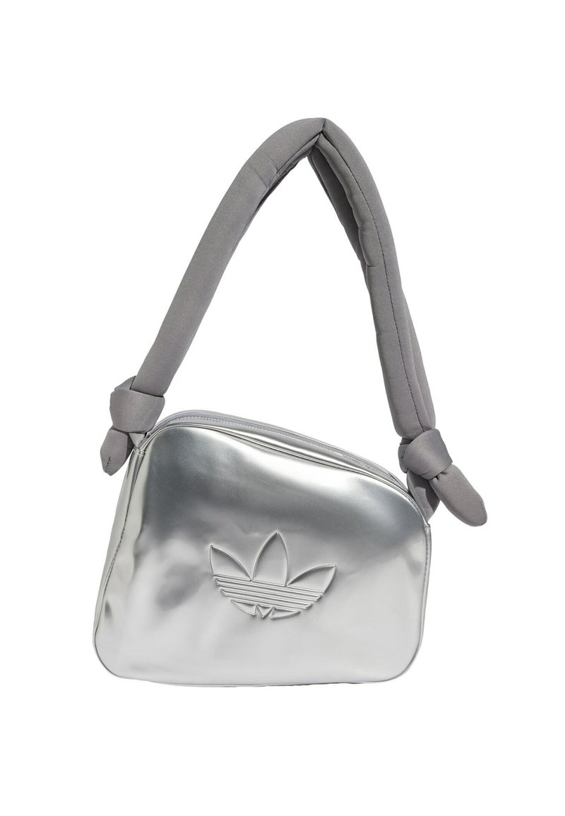 Silver metallic shoulder bag with a padded gray strap, featuring a zip closure and embossed logo design on the front.